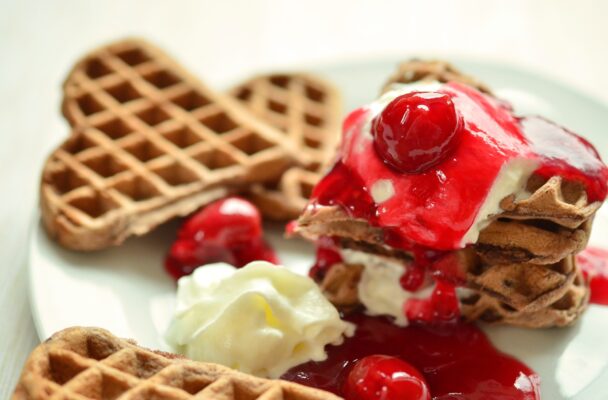 Crispy and fluffy homemade waffle recipe served with maple syrup and berries