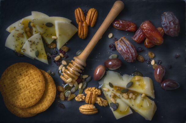 A bowl of fresh Medjool dates on a rustic wooden table, highlighting their rich texture and natural sweetness—perfect for a healthy daily snack or sugar alternative.
