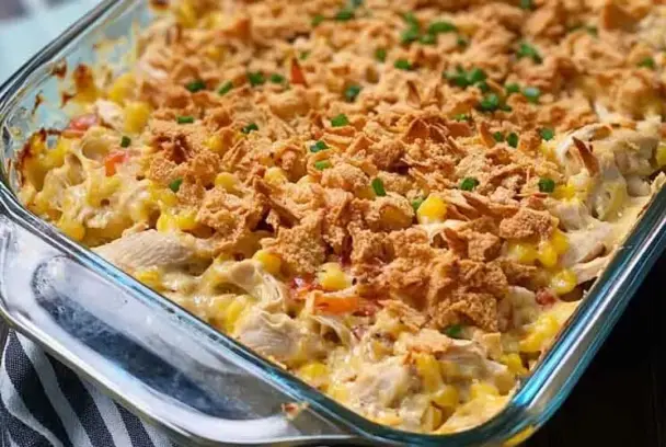 Ultimate chicken casserole with shredded chicken, creamy sauce, pasta, and melted cheese baked to golden perfection in a casserole dish.