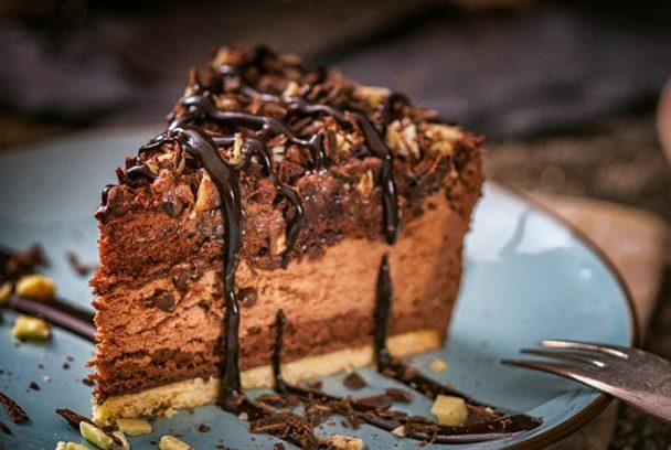 A decadent German Chocolate Cake with rich chocolate layers and coconut-pecan frosting on top, perfect for special occasions