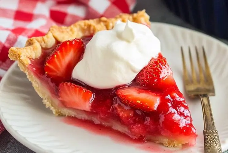 Freshly made Big Boy’s Fresh Strawberry Pie filled with vibrant strawberries and topped with glossy glaze in a golden flaky crust — perfect summer dessert.