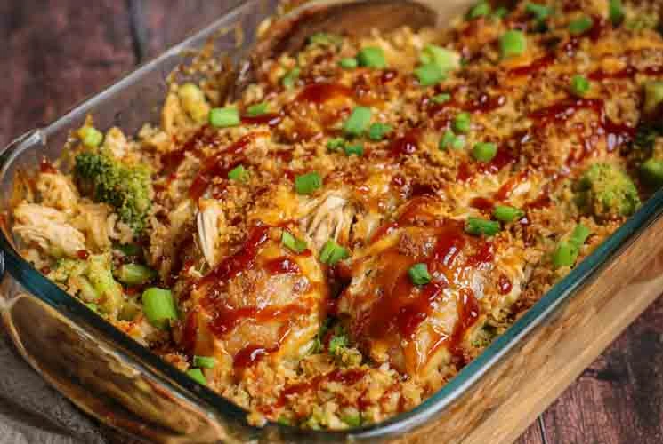 Glass baking dish filled with Teriyaki Chicken Casserole, showing shredded chicken, broccoli, rice, and a glossy teriyaki sauce, topped with chopped green onions.